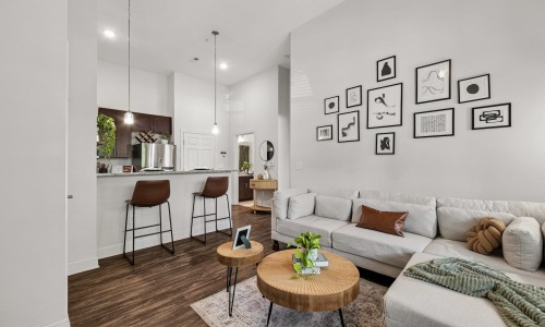 a living room with a couch, coffee table and chairs