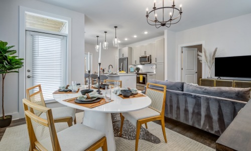 a dining room with a table, chairs and a couch