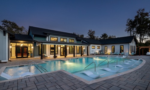 a swimming pool with lounge chairs 