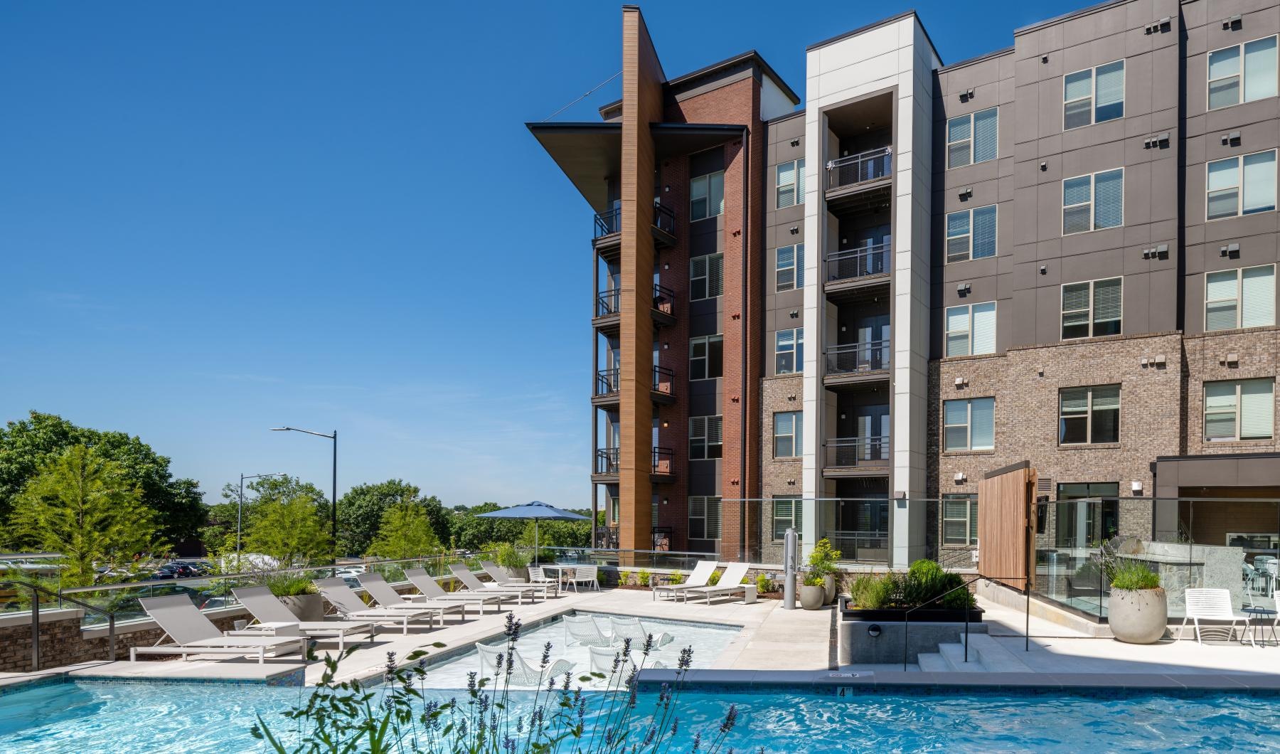 Settle into comfort at Union Heights a building with a pool in front