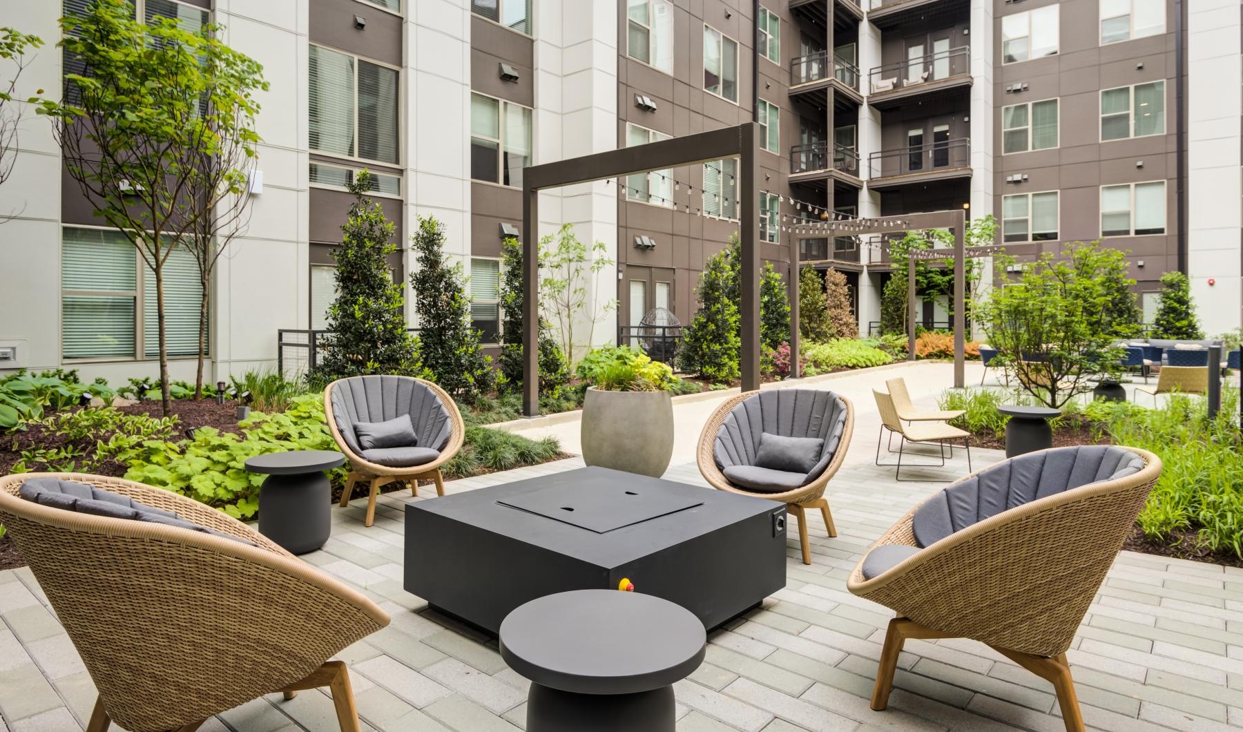 Settle into comfort at Union Heights a patio with chairs and tables outside a building