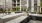 a courtyard with chairs and tables outside a building