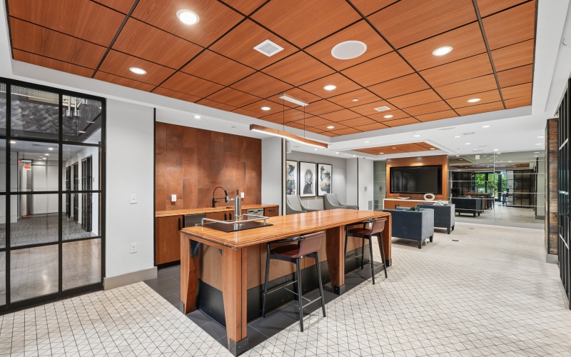 Resident kitchen with bar seating and couches